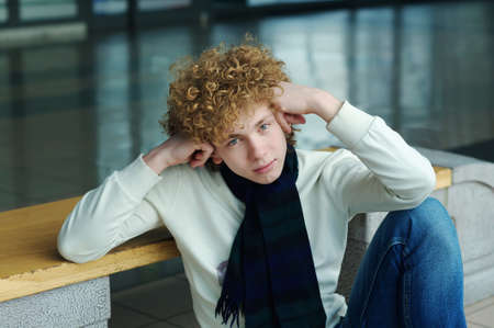 portrait of a young man with curly hairの写真素材