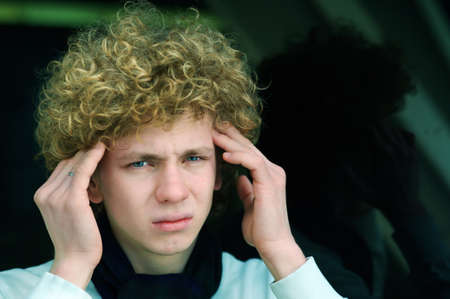 portrait of a young man with curly hairの写真素材