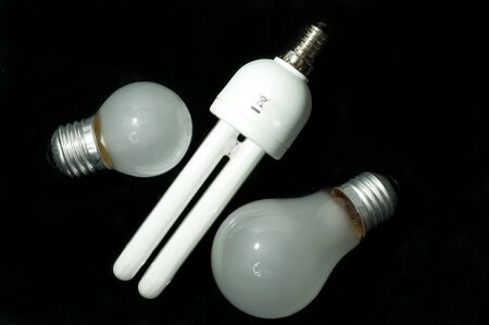Energy saving light bulb and tungsten on a black backgroundの写真素材
