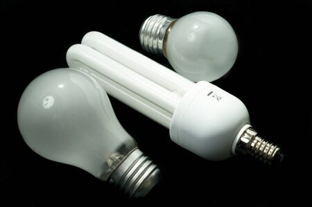 Energy saving light bulb and tungsten on a black backgroundの写真素材