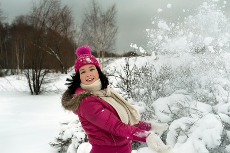 beautiful girl in the background of a snowy forestの写真素材