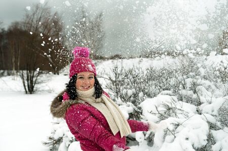 beautiful girl in the background of a snowy forestの写真素材