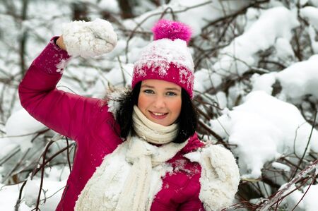 beautiful girl in the background of a snowy forestの写真素材