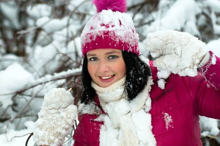 beautiful girl in the background of a snowy forestの写真素材