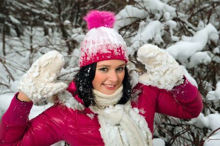 beautiful girl in the background of a snowy forestの写真素材