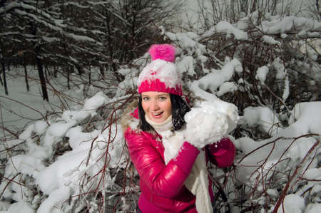 beautiful girl in the background of a snowy forestの写真素材
