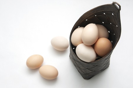 Eggs from the village in a brown basketの写真素材