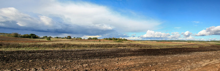 Arable fields in sunny autumn day with cloudsの写真素材