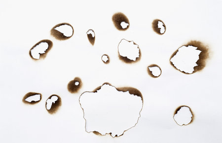 burnt holes in the paperの写真素材
