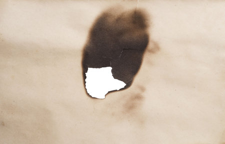 burnt hole in a paperの写真素材