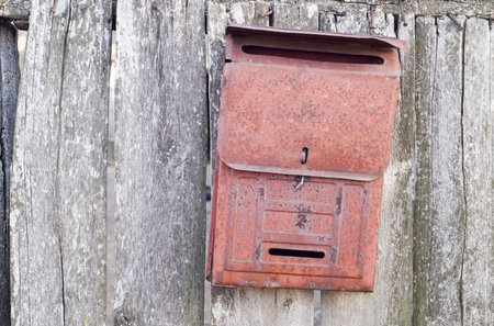 old mail box on the wooden doorの写真素材
