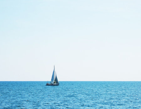 sailboat on blue ocean against sky