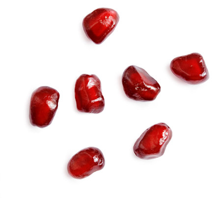 pomegranate seeds over white background