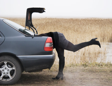 a woman repairing her autoの写真素材