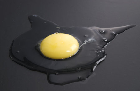 raw egg over black backgroundの写真素材