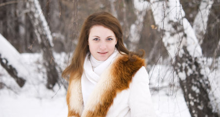 young beautiful woman in winter forestの写真素材