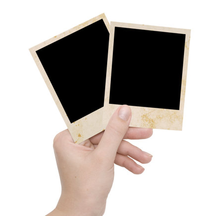 two photo frames on a hand over whiteの写真素材