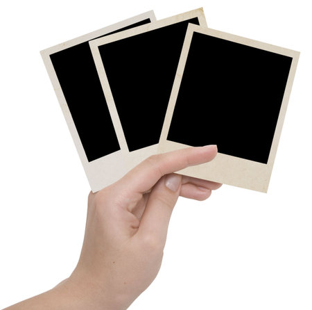 three photo frames in a hand over whiteの写真素材