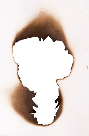 burnt hole in a paperの写真素材