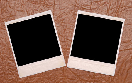 two photos on a leather backgroundの写真素材