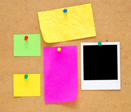 empty notes and photo frame on wooden backgroundの写真素材