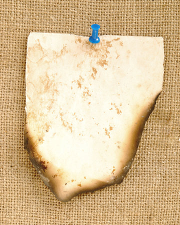 old burnt paper over sackcloth backgroundの写真素材