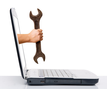 hand with wrench comes from laptop screenの写真素材