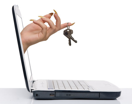 hand with keys comes from laptop screen isolated on whiteの写真素材