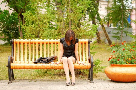 sad woman in the parkの写真素材