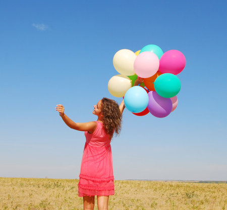 young happy woman with balloonsの写真素材