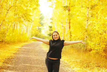 happy woman in the autumn forestの写真素材