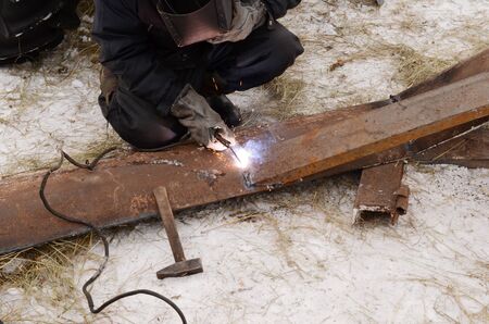 welder working with metal construction