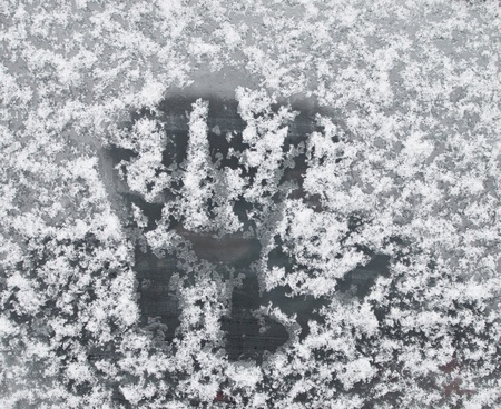 hand trace on the frozen snow glassの写真素材