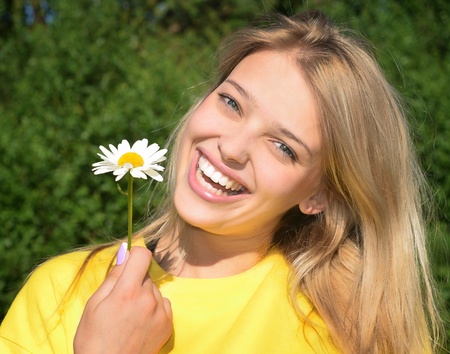 portrait of young beautiful woman with flowerの写真素材