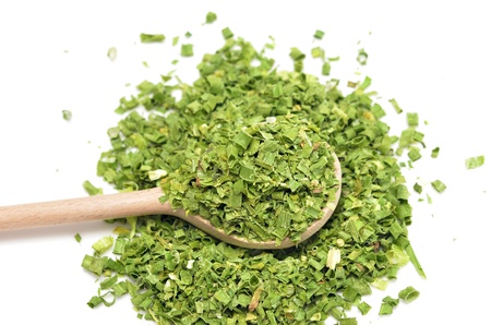 dry onion in wooden spoon isolated on whiteの写真素材