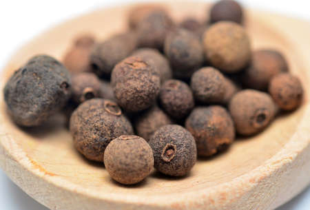 black pepper in a wooden spoon