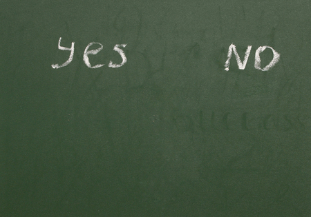 "yes" and "no" written on blackboardの写真素材