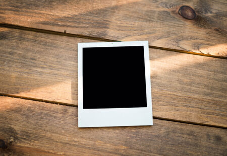photo frame on wood backgroundの写真素材