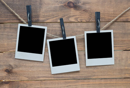 empty photo frames on wooden backgroundの写真素材