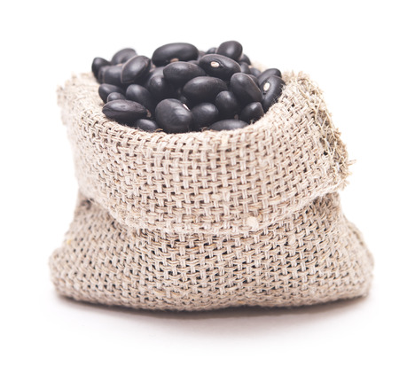 black beans in a sack isolated on white backgroundの写真素材