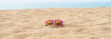 red sunglasses at the beachの写真素材