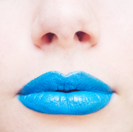 close up shot of woman lips with blue lipstickの写真素材