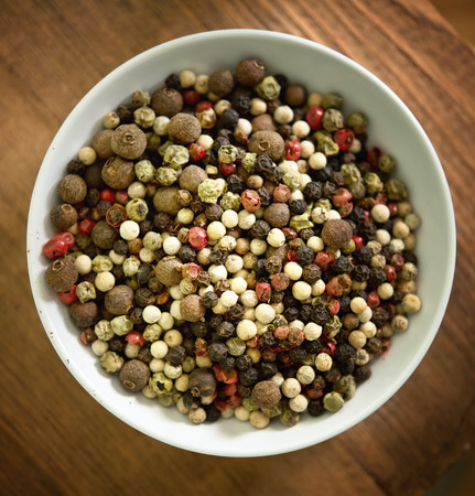 various pepper on wooden background