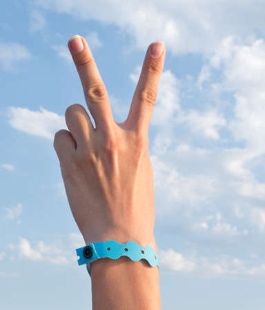 hand with all inclusive bracelet over sea backgroundの写真素材