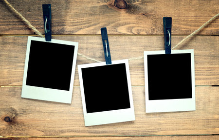 empty polaroid photo frames on wooden backgroundの写真素材
