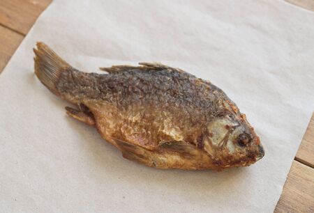 close up of fried fish on wooden tableの写真素材