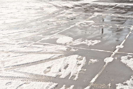 wheel and foot prints in the fresh snowの写真素材