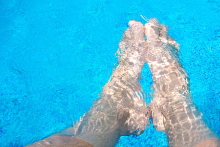 male legs in the pool waterの写真素材