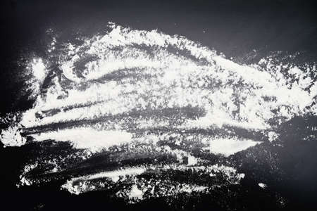 white powder (flour) on black backgroundの写真素材