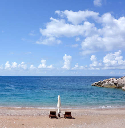 chairs and umbrella on a beautiful beachの写真素材